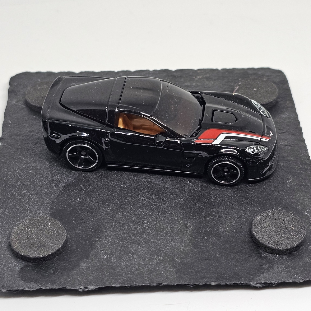 Black Diecast Model Car with Red Stripe